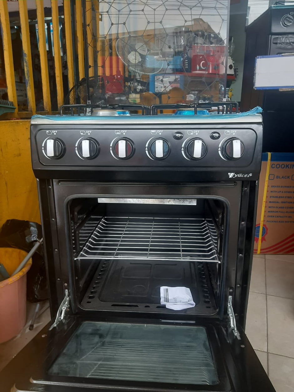 Four de Grande gazinière Yucel 4 feux inox vue de profil avec couvercle vitré