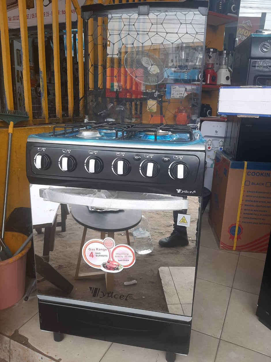 Grande gazinière Yucel 4 feux inox vue de profil avec couvercle vitré